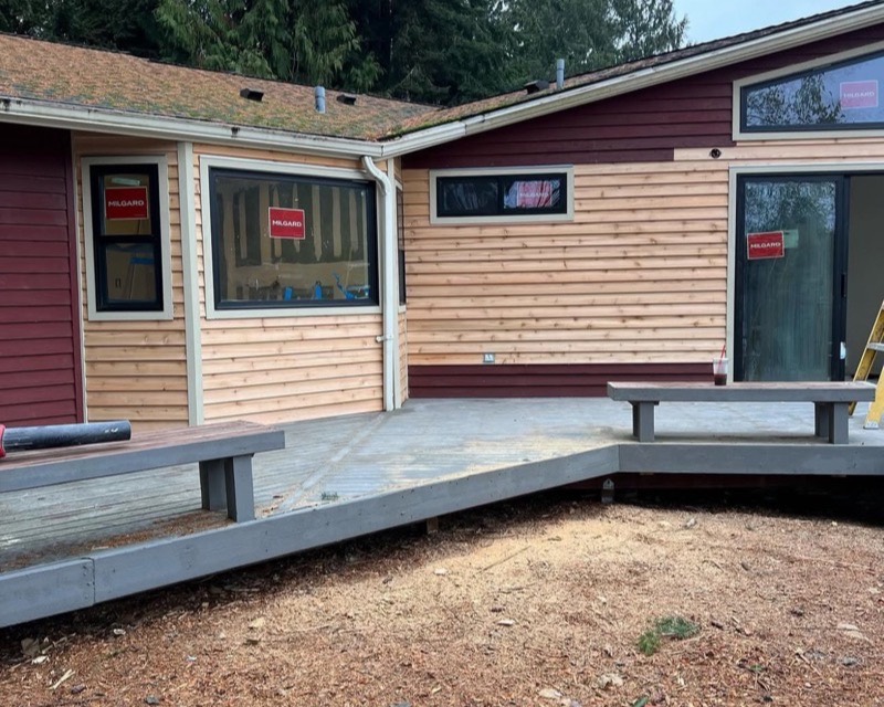 Exterior remodel — new cedar siding and composite deck in Poulsbo